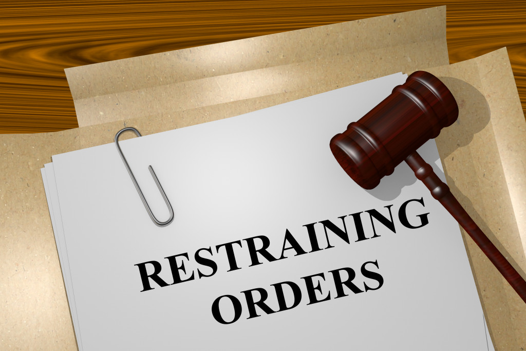 A restraining order document and a gavel