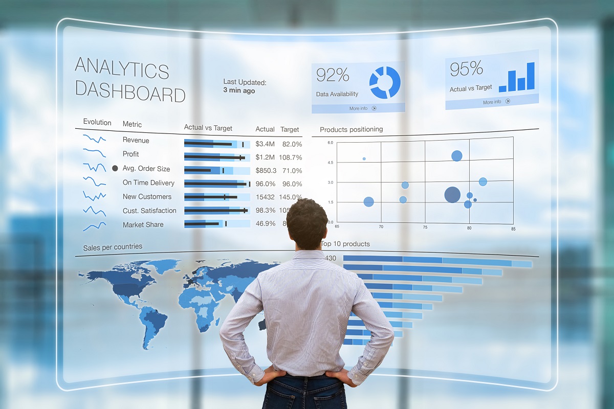 data analytics dashboard being observed by young businessman